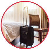 a chair 和 rolling suitcase in a hotel room